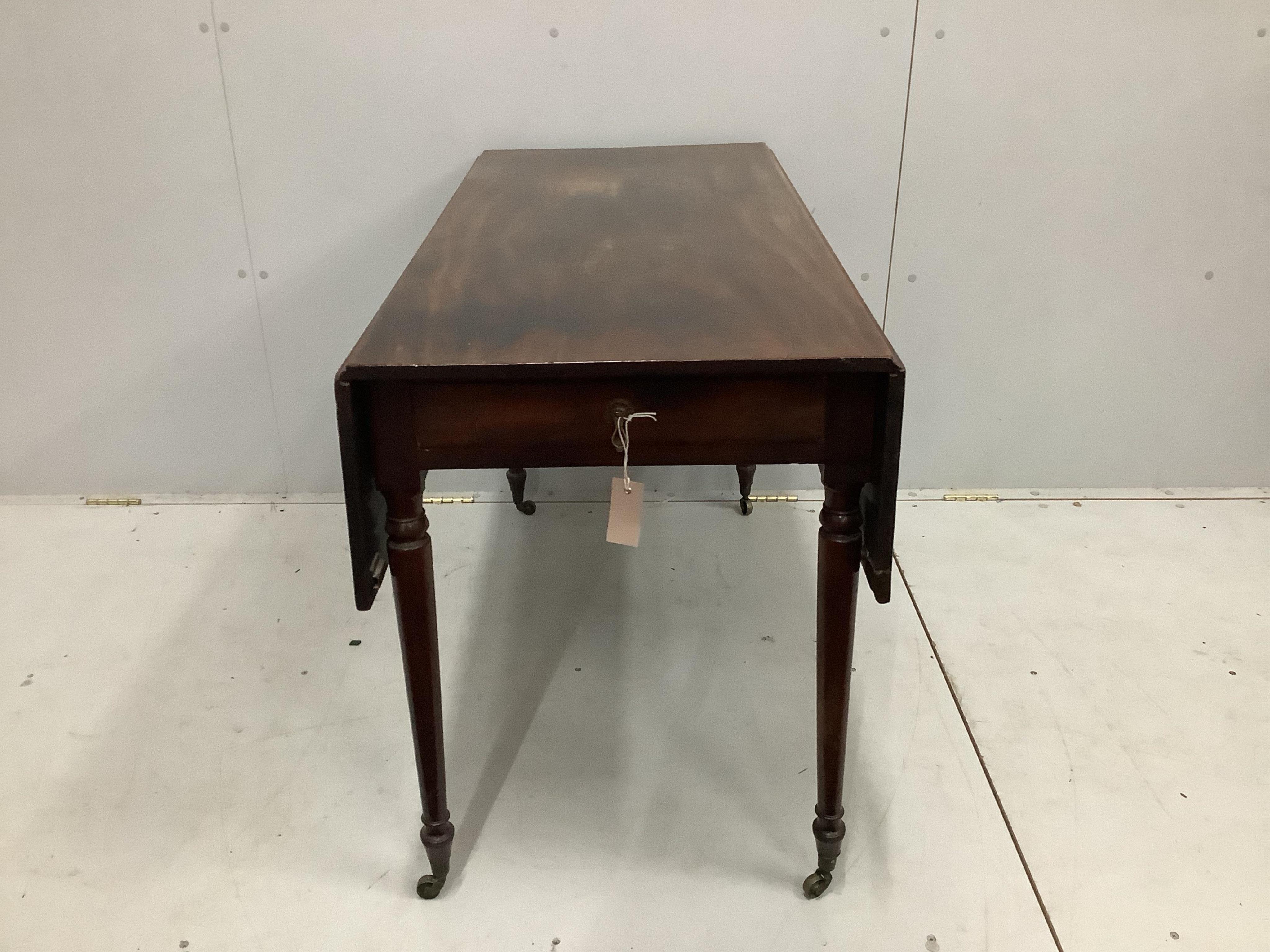 A Regency mahogany Pembroke table, on turned legs with castors, width 112cm, depth 53cm, height 72cm. Condition - fair